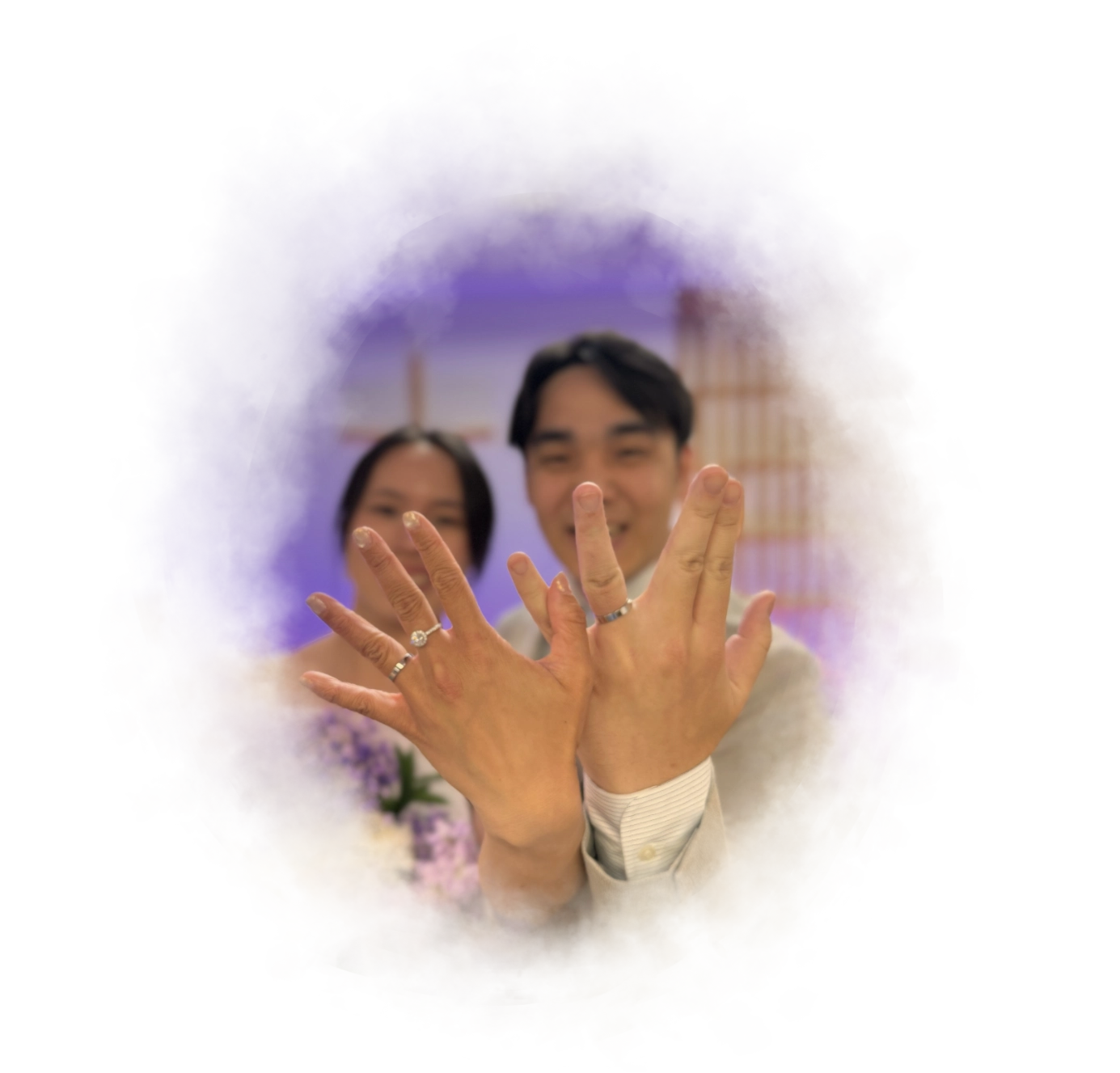 A photo of Kaming and Claudia showing off their wedding rings